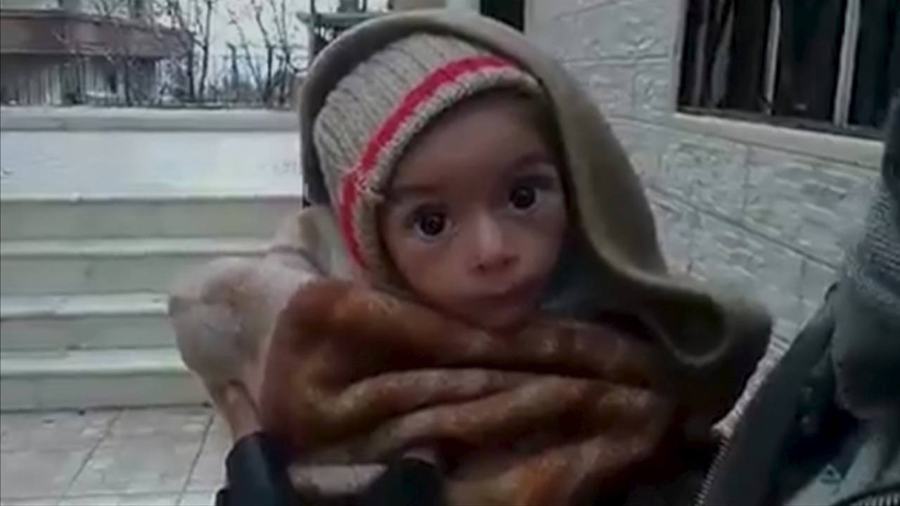 A toddler is held up to the camera in this still image taken from video said to be shot in Madaya on January 5, 2016. Warnings of widespread starvation are growing as pro-government forces besiege an opposition-held town in Syria and winter bites, darkening the already bleak outlook for peace talks the United Nations hopes to convene this month. To match MIDEAST-CRISIS/SYRIA-TOWN Handout via Social Media Website ATTENTION EDITORS - THIS PICTURE WAS PROVIDED BY A THIRD PARTY. REUTERS IS UNABLE TO INDEPENDENTLY VERIFY THE AUTHENTICITY, CONTENT, LOCATION OR DATE OF THIS IMAGE. FOR EDITORIAL USE ONLY. NOT FOR SALE FOR MARKETING OR ADVERTISING CAMPAIGNS. THIS PICTURE IS DISTRIBUTED EXACTLY AS RECEIVED BY REUTERS, AS A SERVICE TO CLIENTS. EDITORIAL USE ONLY. NO RESALES. NO ARCHIVE.